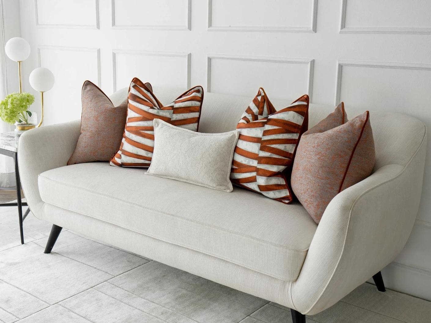 Topaz Bundle cushion in orange, white and red, shown in a lifestyle right view as image 2
