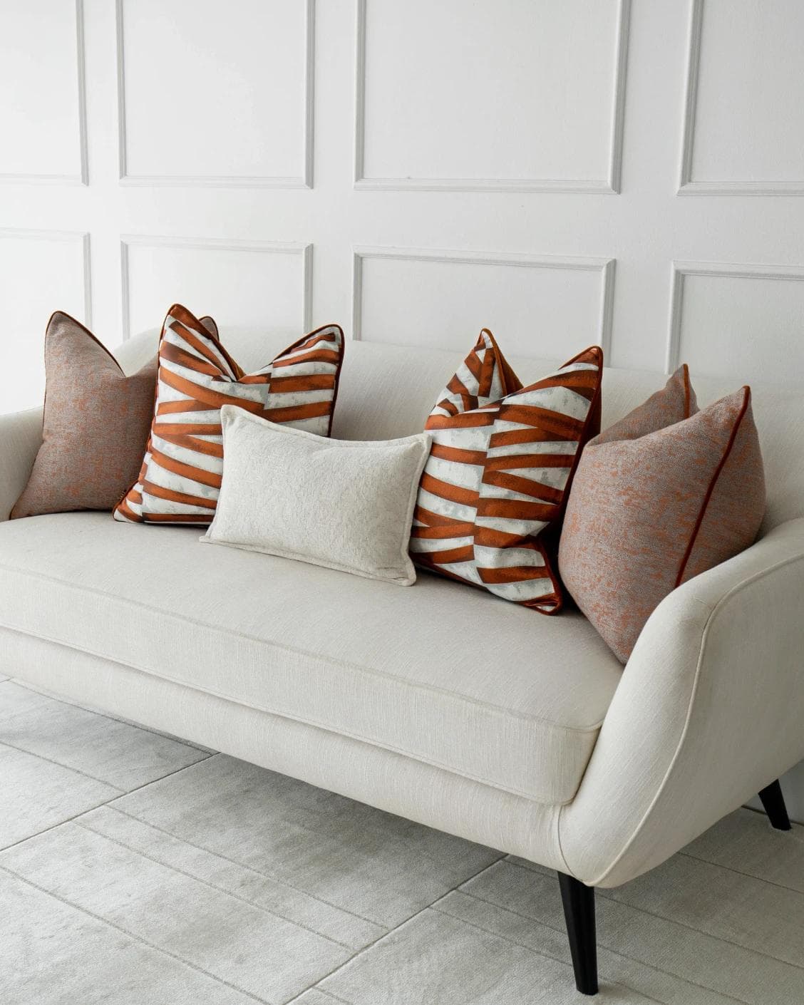 Topaz Bundle cushion in orange, white and red, shown in a lifestyle right view as image 2