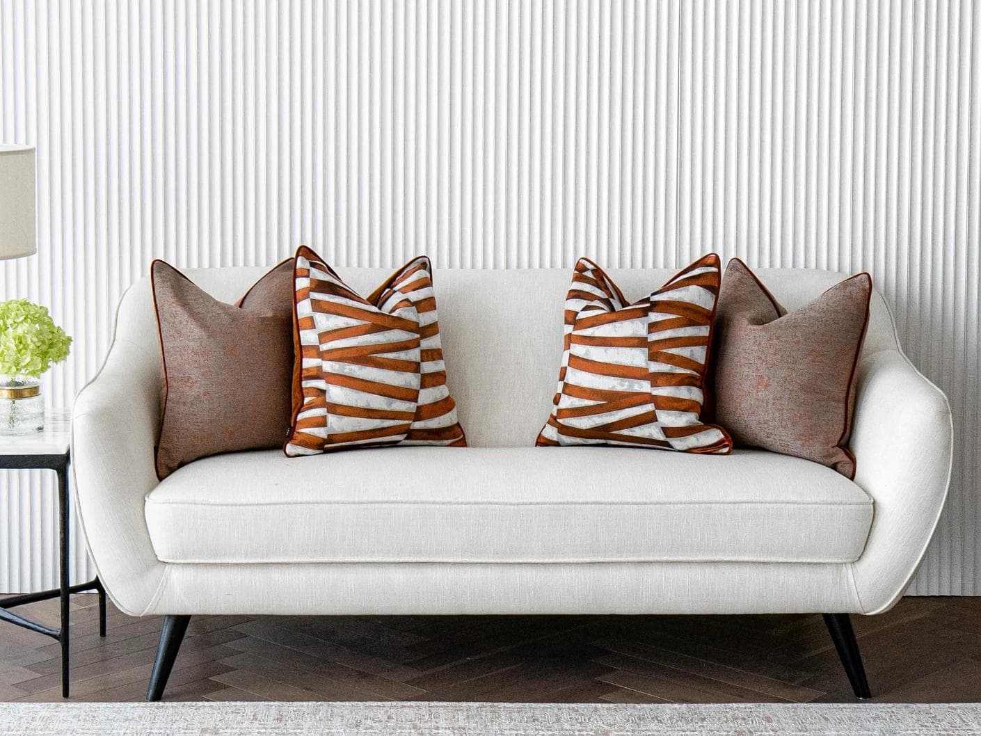 Alani Bundle cushion in orange, white and red, shown in a lifestyle front view as image 4