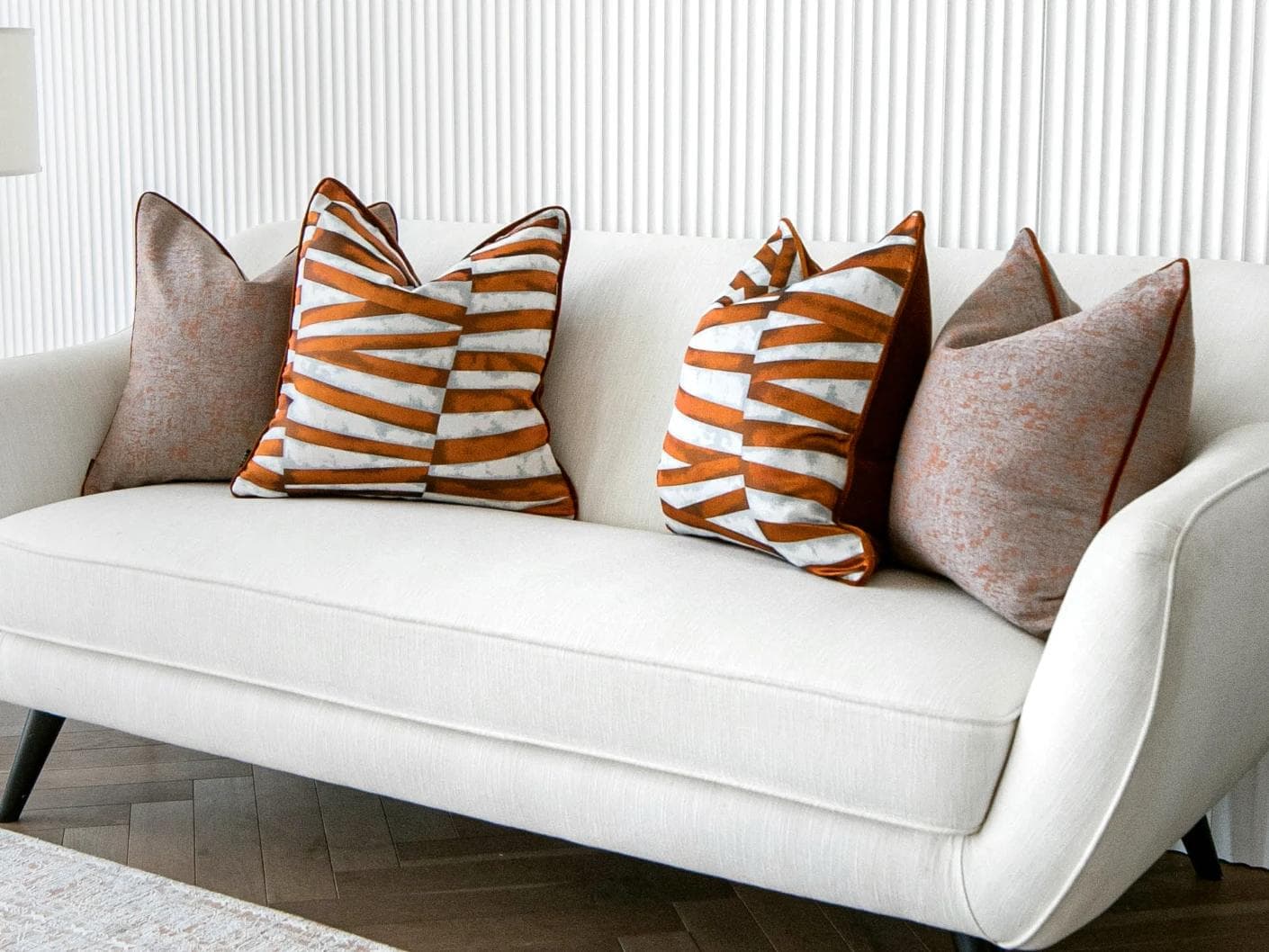 Alani Bundle cushion in orange, white and red, shown in a lifestyle right view as image 2
