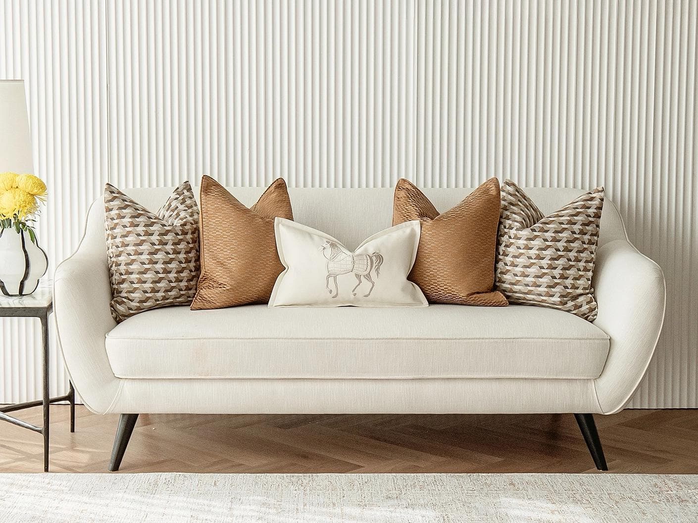 Nerola Bundle cushion in orange, beige and white, shown in a lifestyle front view as image 4