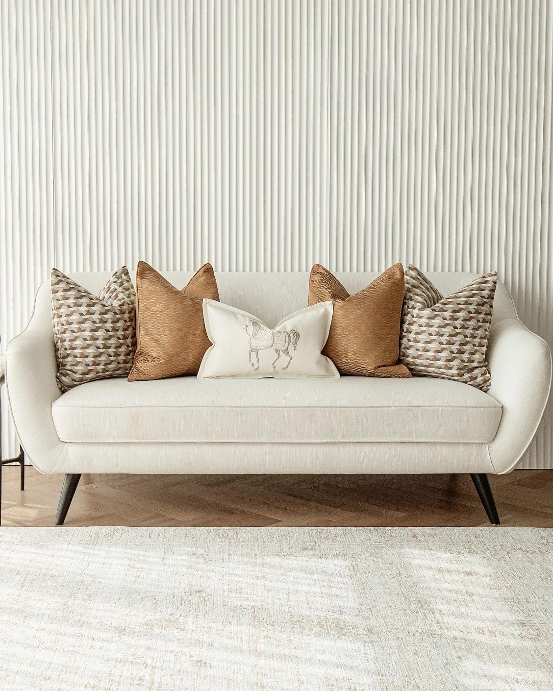 Nerola Bundle cushion in orange, beige and white, shown in a lifestyle front view as image 4