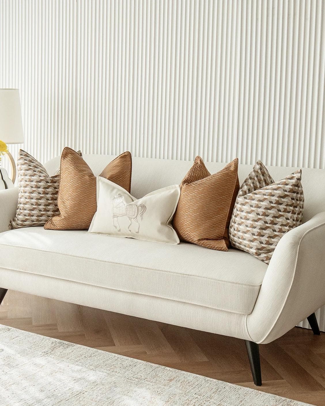 Nerola Bundle cushion in orange, beige and white, shown in a lifestyle right view as image 2
