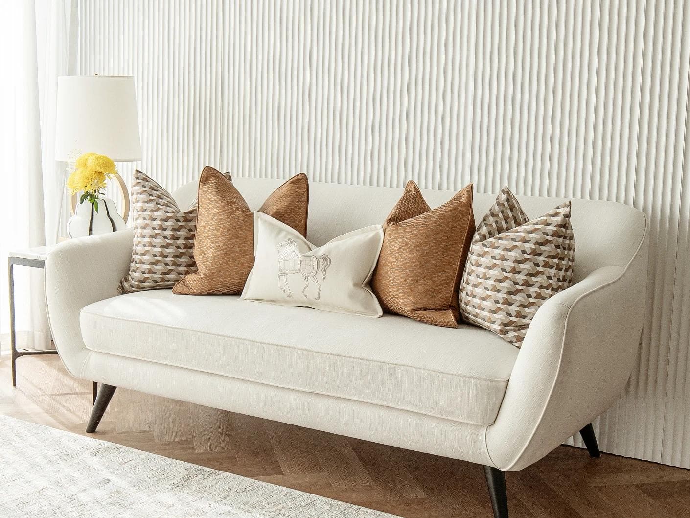 Nerola Bundle cushion in orange, beige and white, shown in a lifestyle right view as image 2