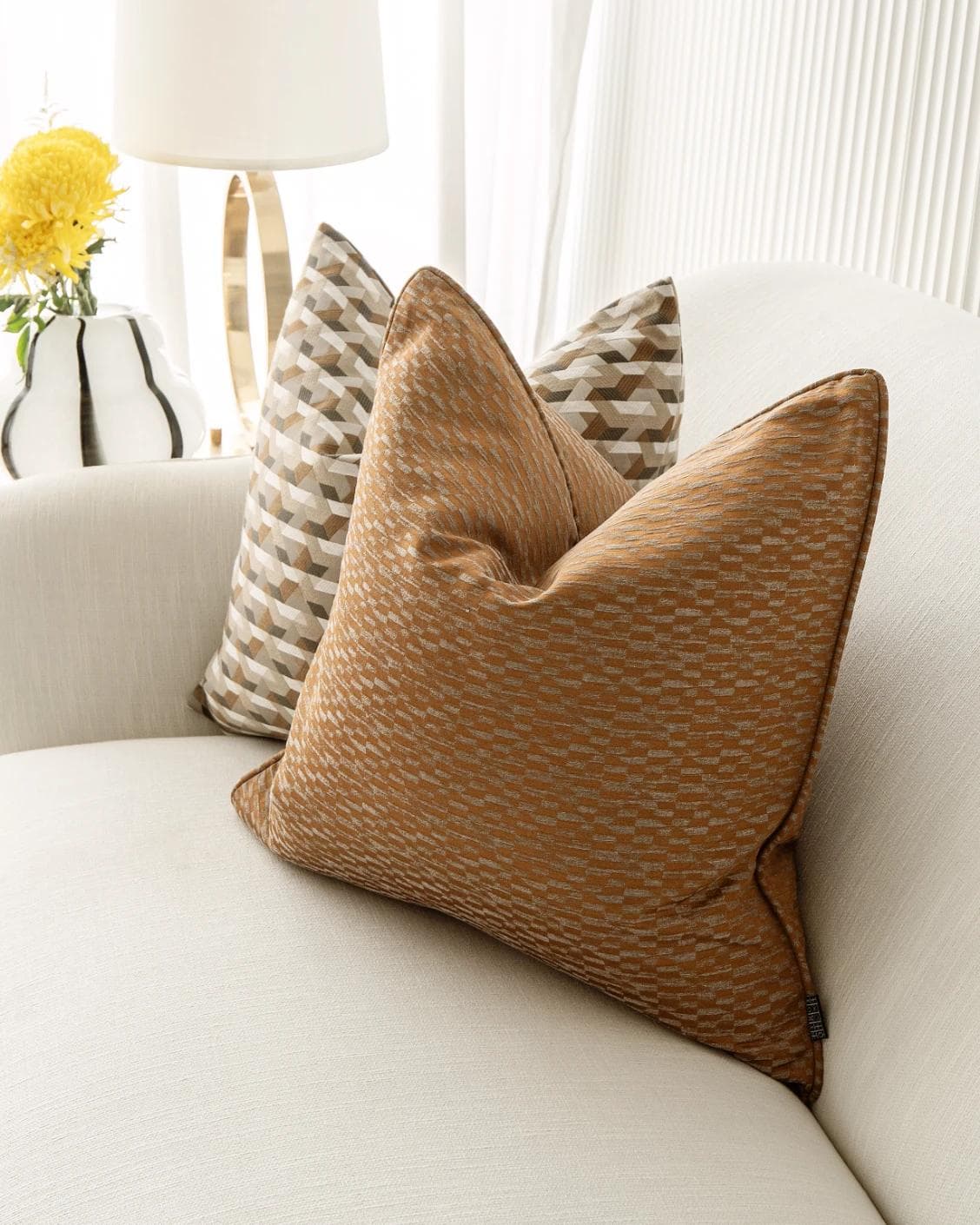 Nerola Bundle cushion in orange, beige and white, shown in a lifestyle right view as image 5