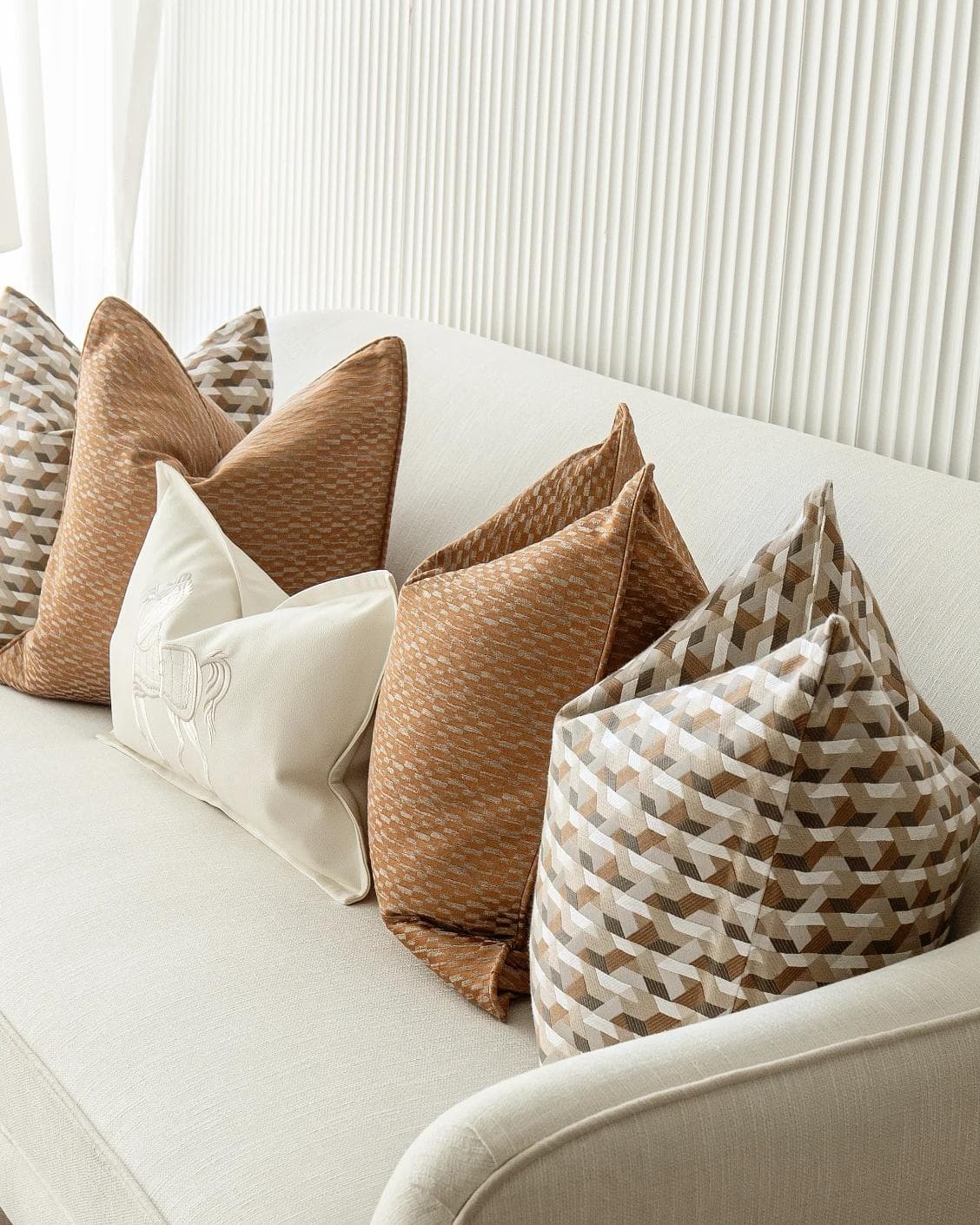 Nerola Bundle cushion in orange, beige and white, shown in a product right view as image 8
