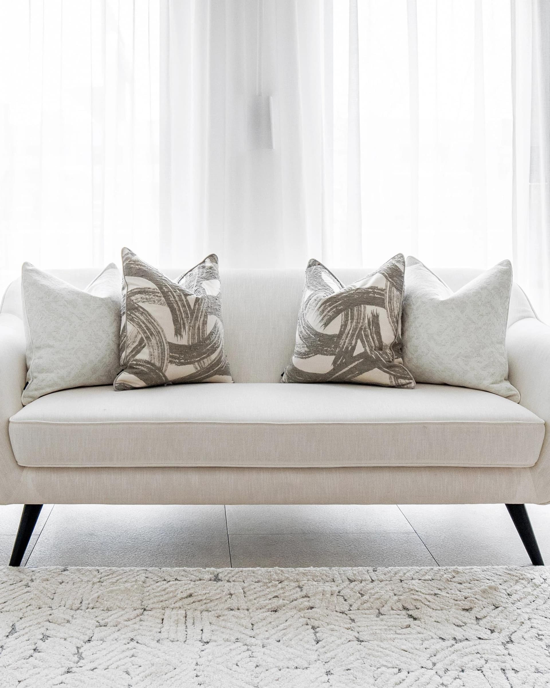 Gianna Bundle cushion in white and grey, shown in a lifestyle front view as image 6