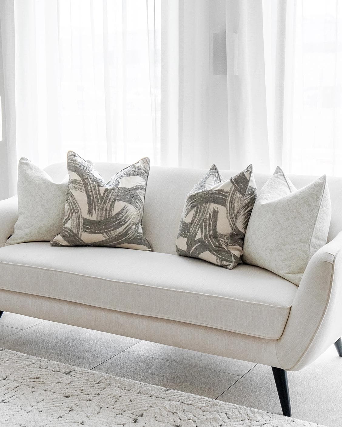 Gianna Bundle cushion in white and grey, shown in a lifestyle right view as image 2