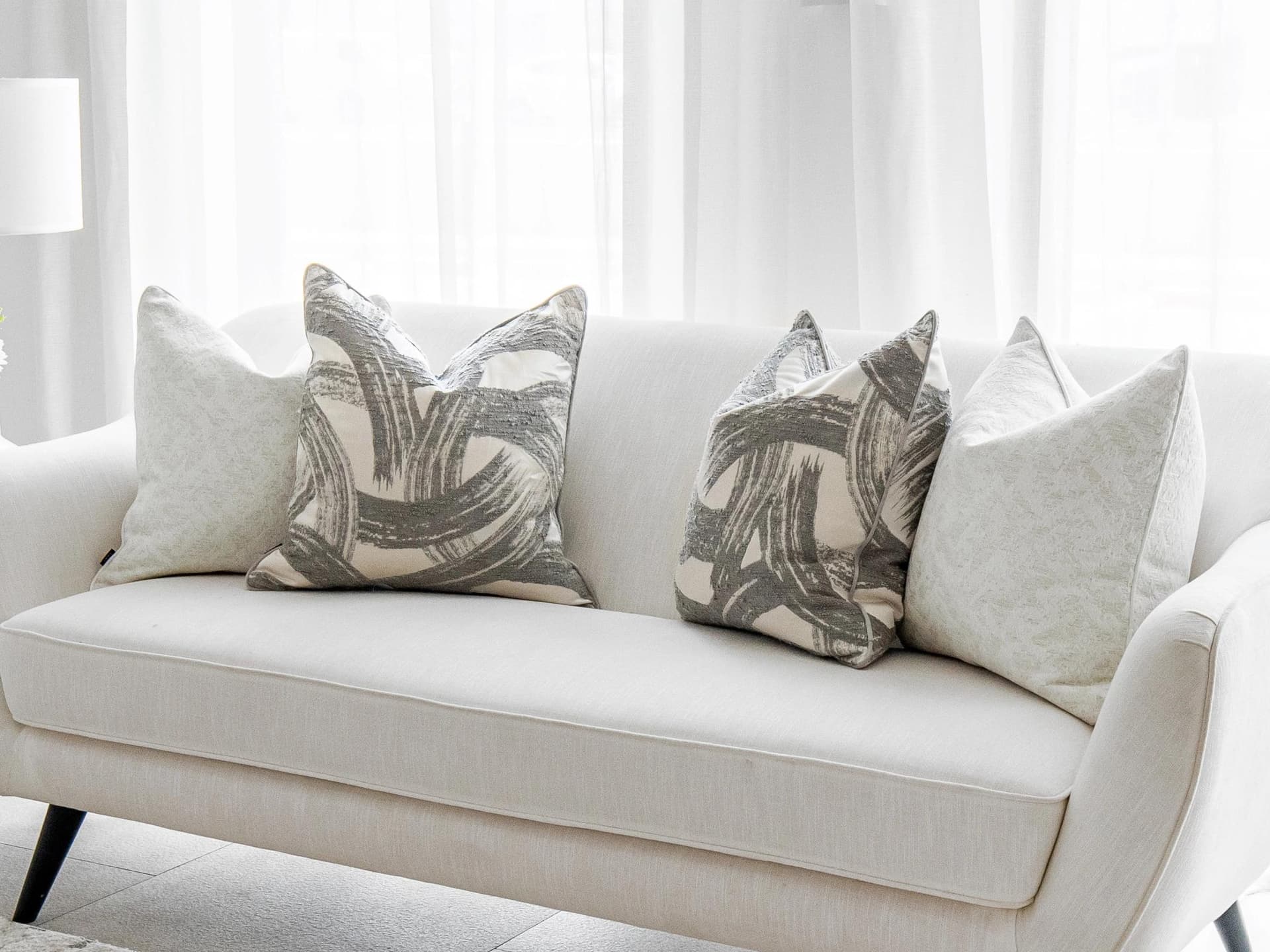 Gianna Bundle cushion in white and grey, shown in a lifestyle right view as image 2