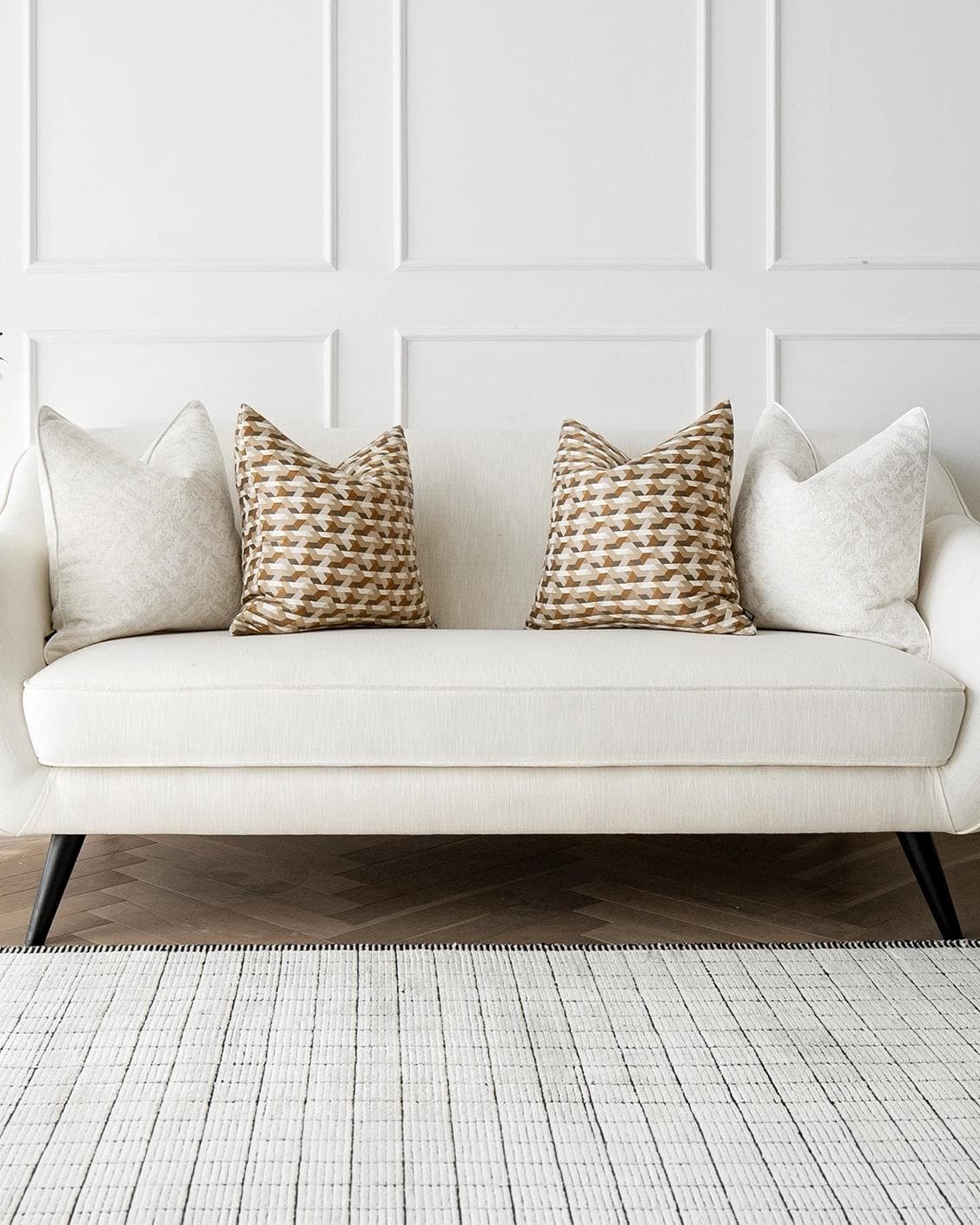 Lorraine Bundle cushion in white, orange and beige, shown in a lifestyle front view as image 4