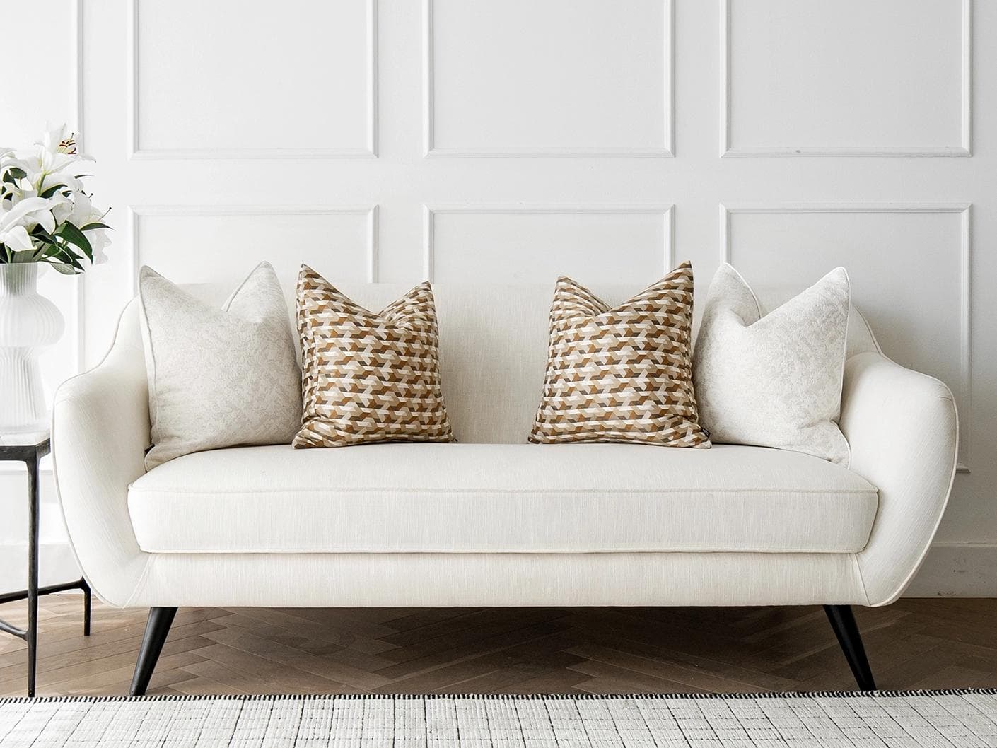 Lorraine Bundle cushion in white, orange and beige, shown in a lifestyle front view as image 4