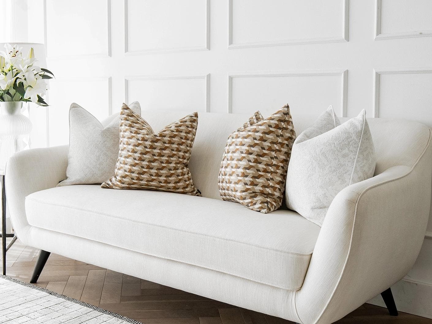 Lorraine Bundle cushion in white, orange and beige, shown in a lifestyle right view as image 2