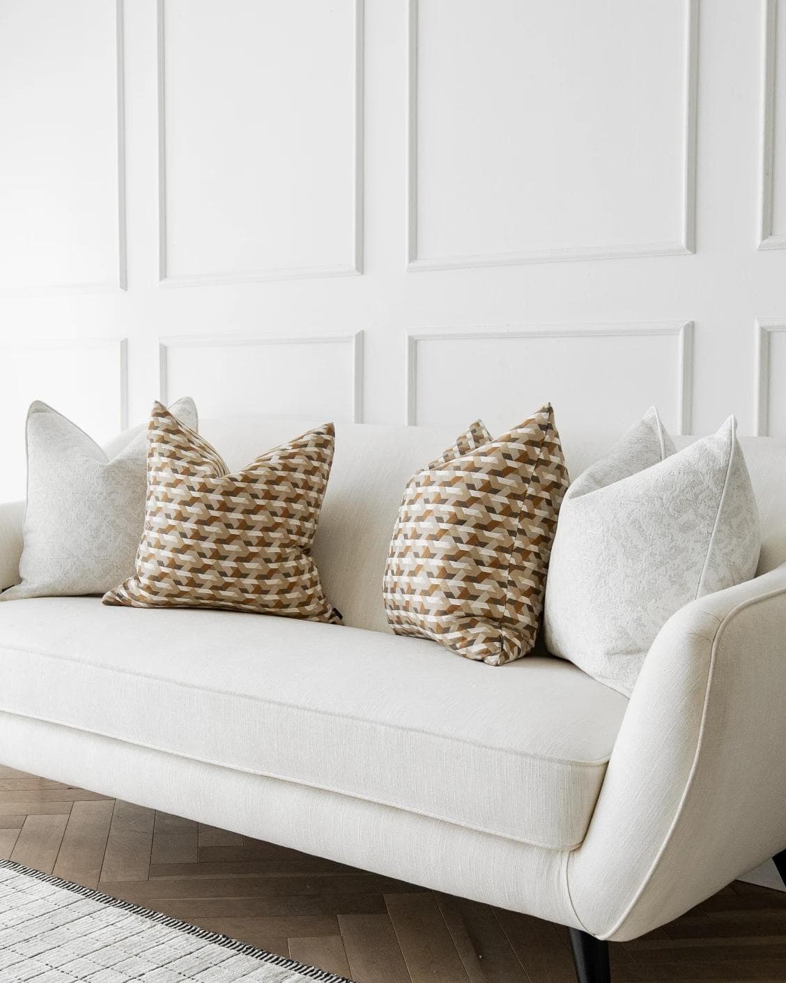 Lorraine Bundle cushion in white, orange and beige, shown in a lifestyle right view as image 2