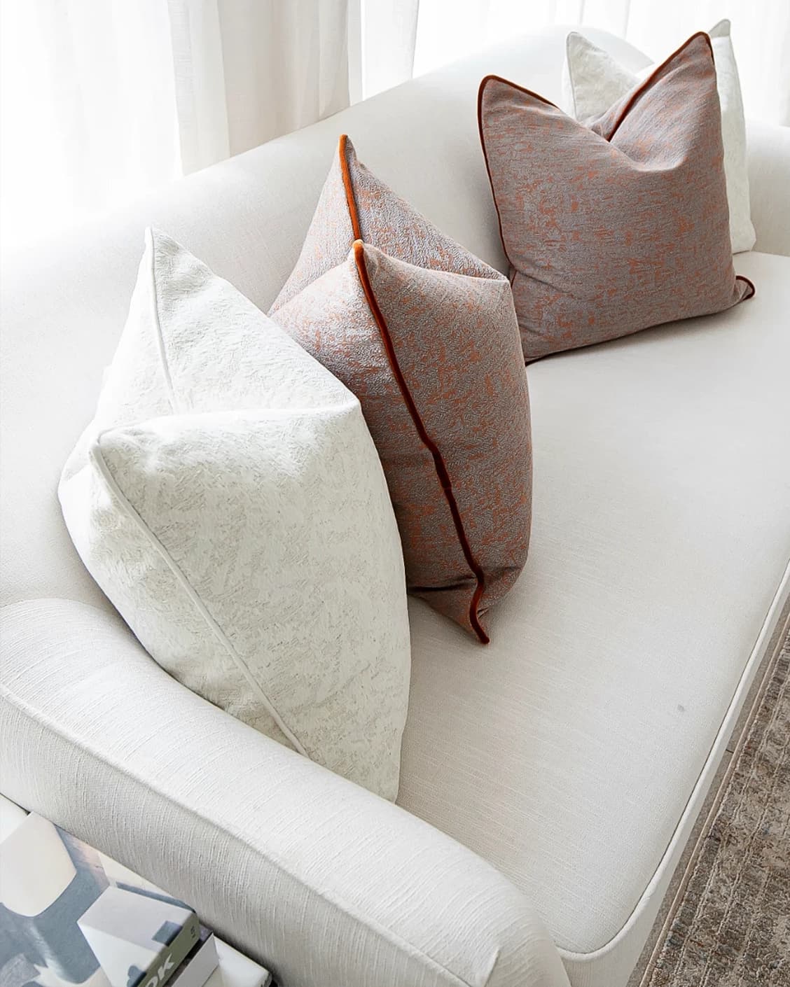 Cassie Bundle cushion in orange, white and red, shown in a lifestyle top view as image 5