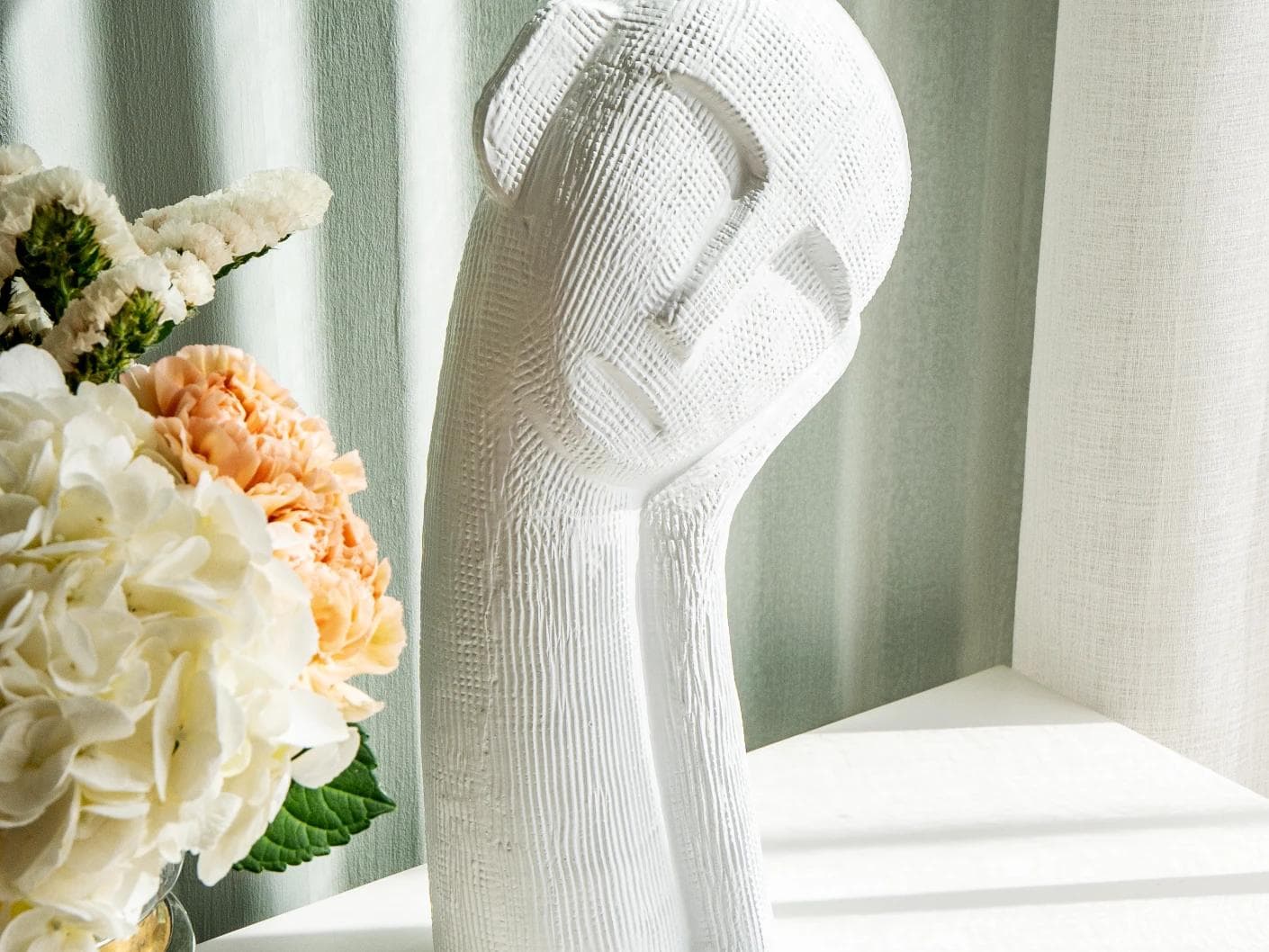 Addie Arneson statues and sculptures in white, shown in a lifestyle close-up left view as image 1