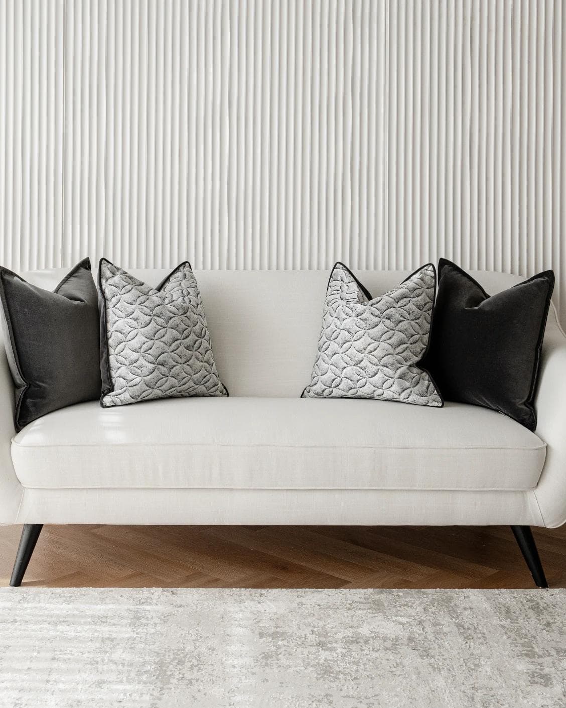 Adham Bundle cushion in black, grey and white, shown in a lifestyle front view as image 4