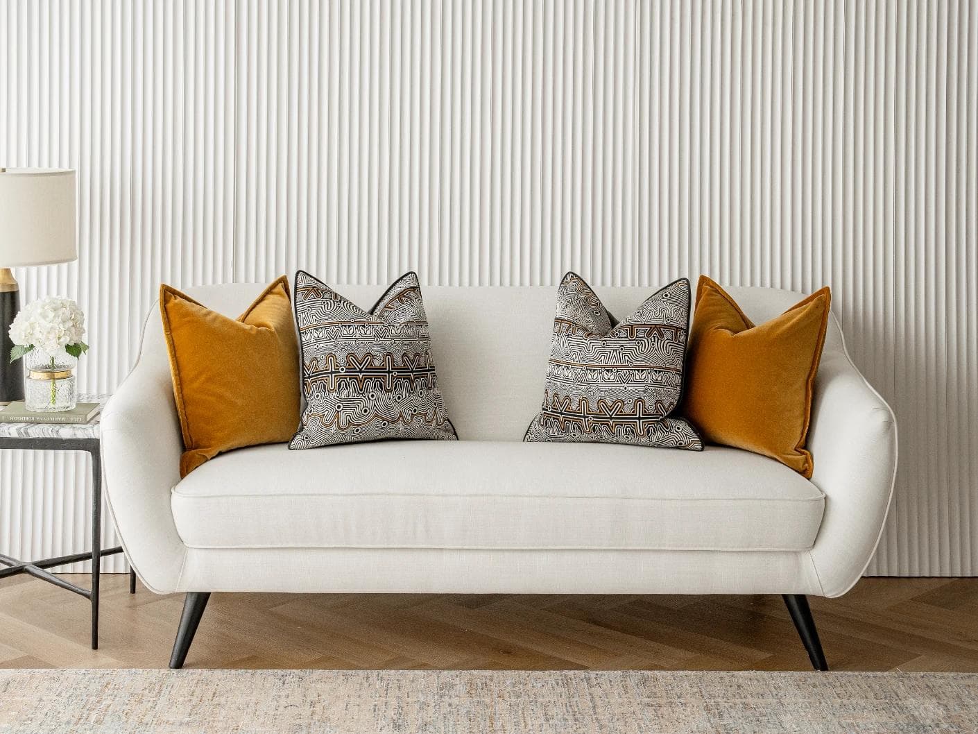 Adin Bundle cushion in orange, black and silver, shown in a lifestyle front view as image 4