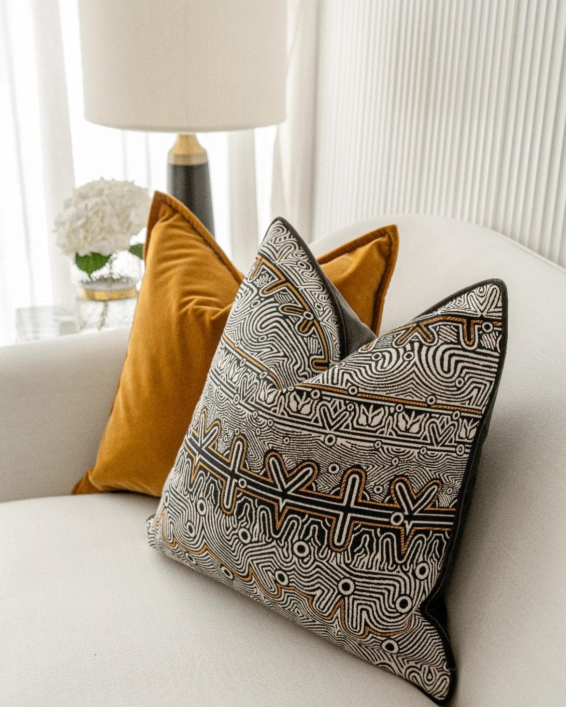 Adin Bundle cushion in orange, black and silver, shown in a lifestyle right view as image 7