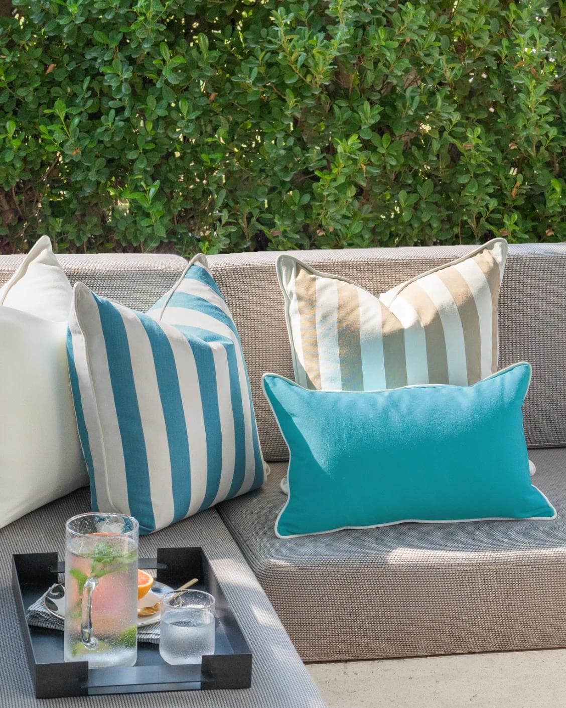 Aditya Bundle cushion in turquoise, beige and ivory, shown in a lifestyle left view as image 4