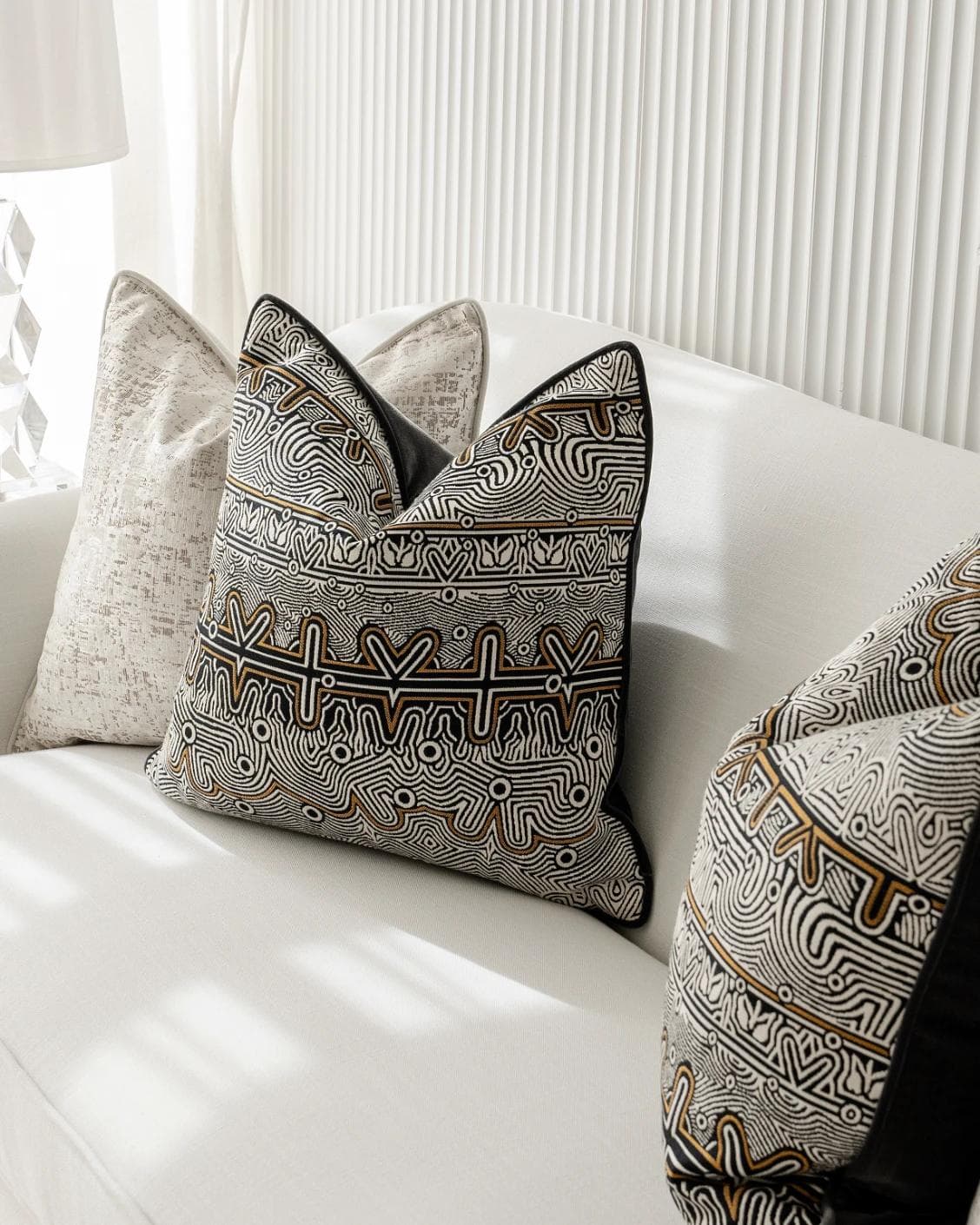 Adonis Bundle cushion in white, black and silver, shown in a lifestyle right view as image 5