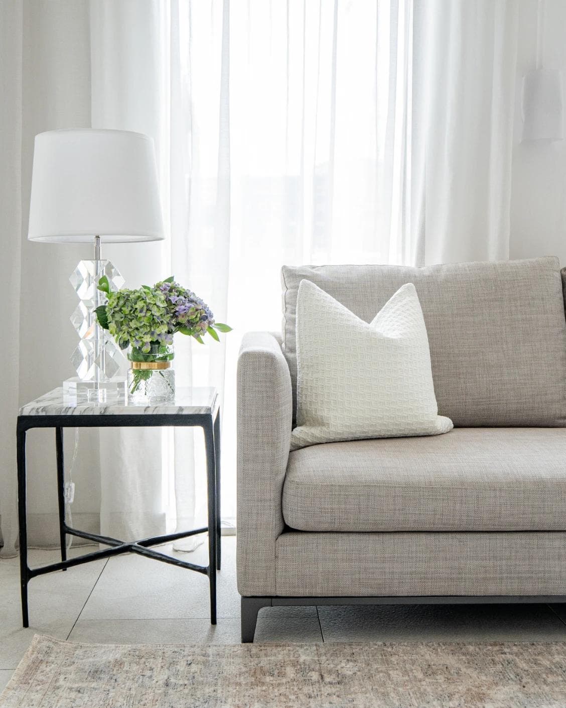Adora Bianca cushion in white, shown in a lifestyle front view as image 4