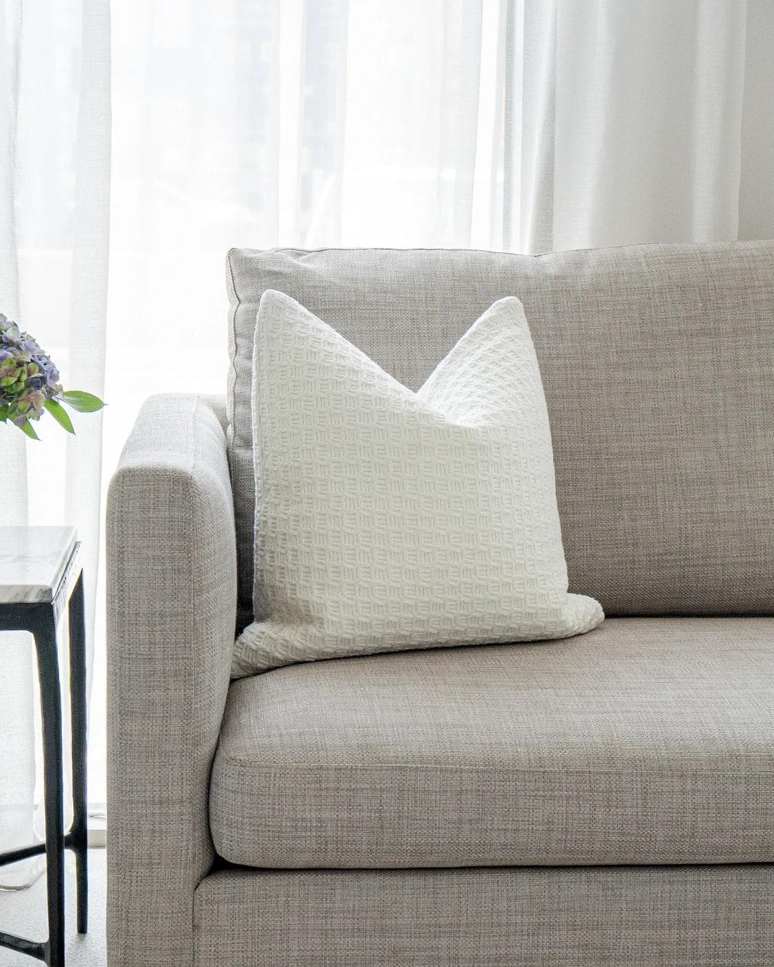 Adora Bianca cushion in white, shown in a lifestyle front view as image 5