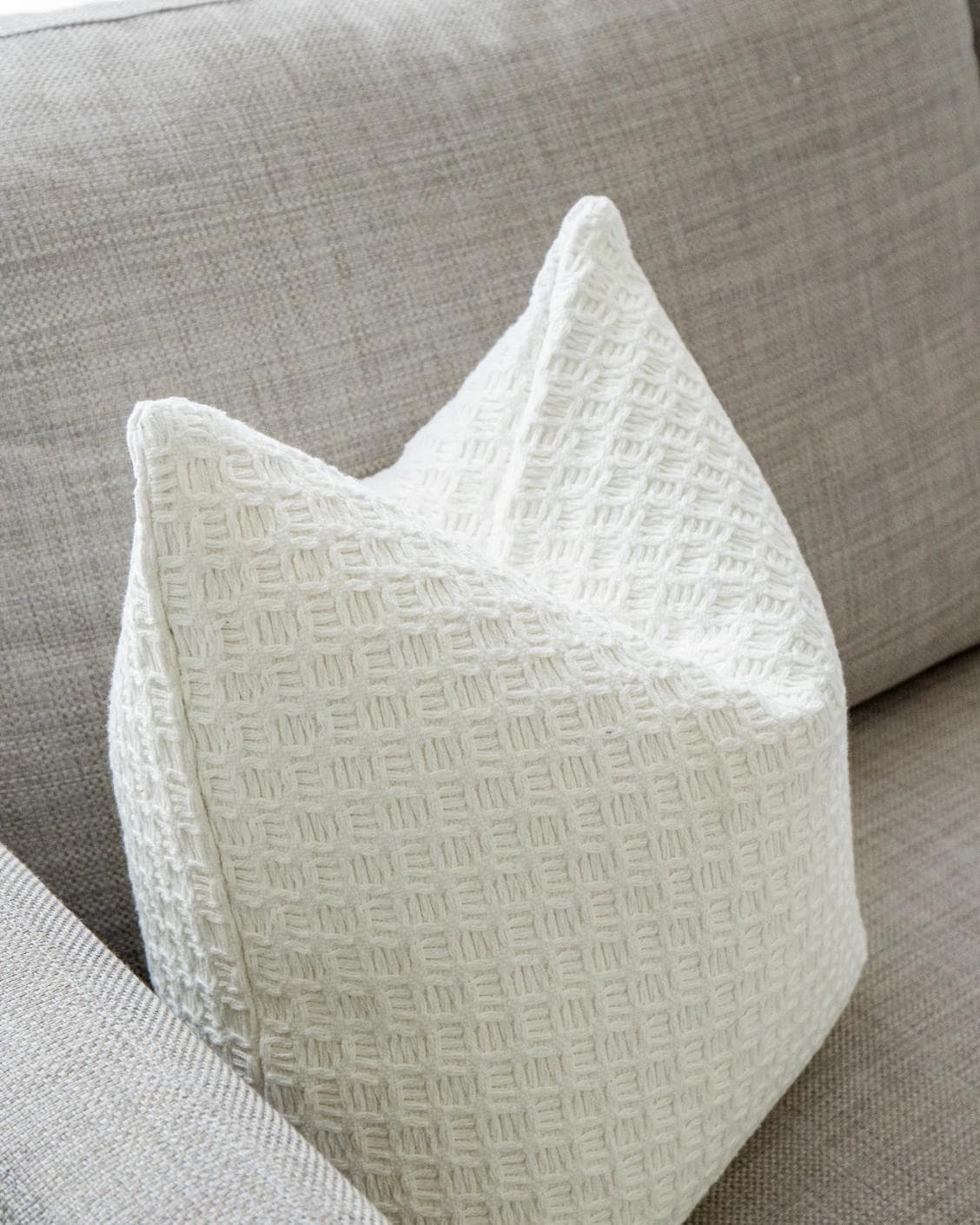 Adora Bianca cushion in white, shown in a lifestyle left view as image 6