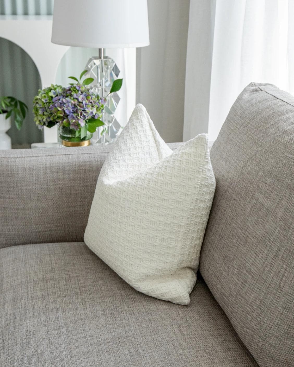 Adora Bianca cushion in white, shown in a lifestyle right view as image 7