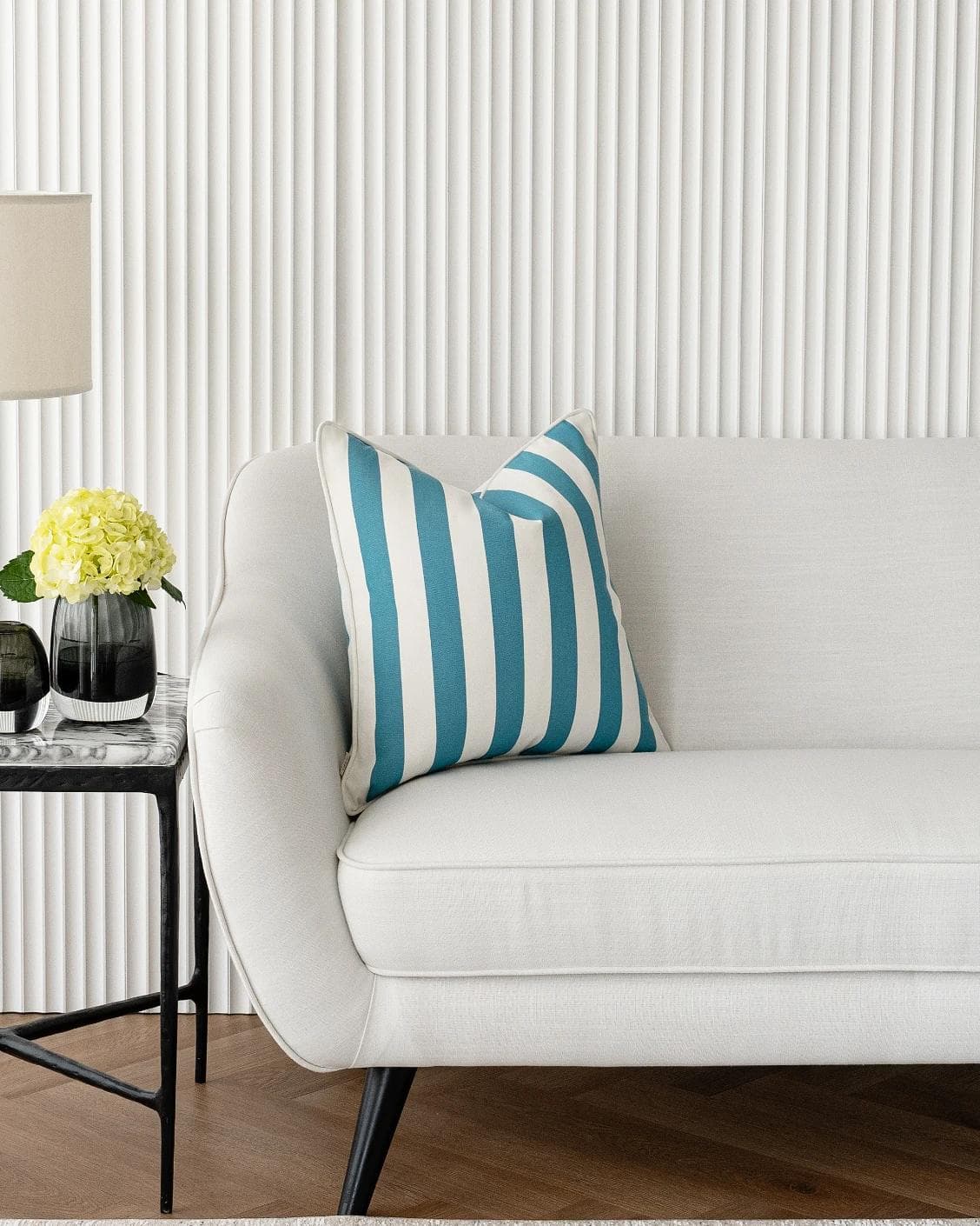 Aelia Azure cushion in blue and soft ivory, shown in a lifestyle left view as image 5