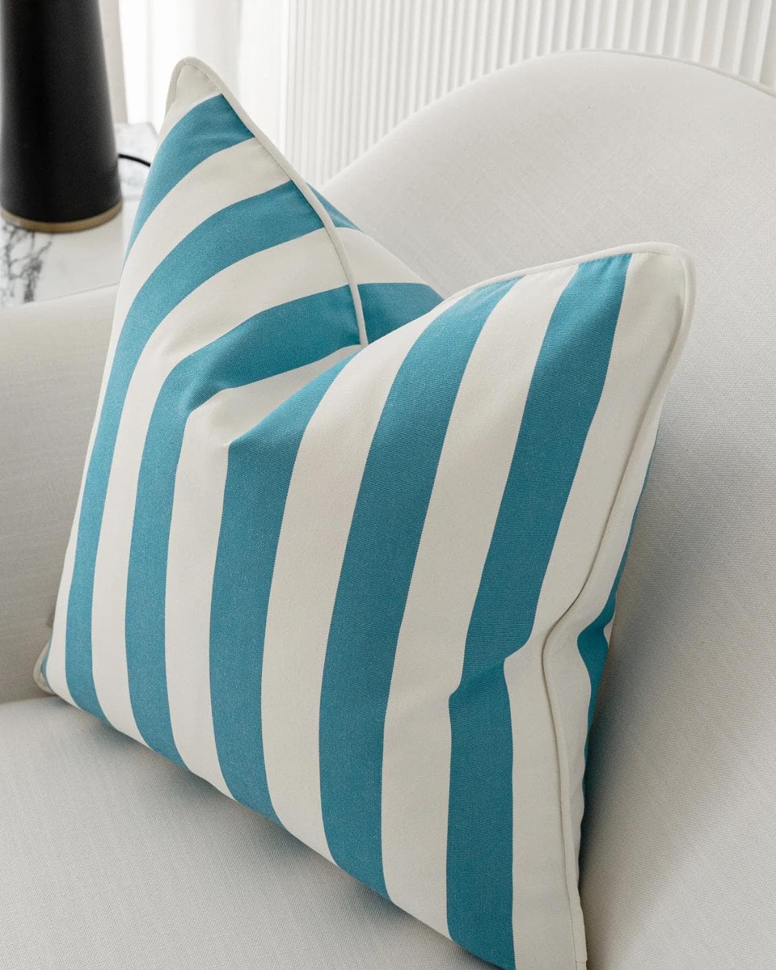 Aelia Azure cushion in blue and soft ivory, shown in a lifestyle right view as image 6
