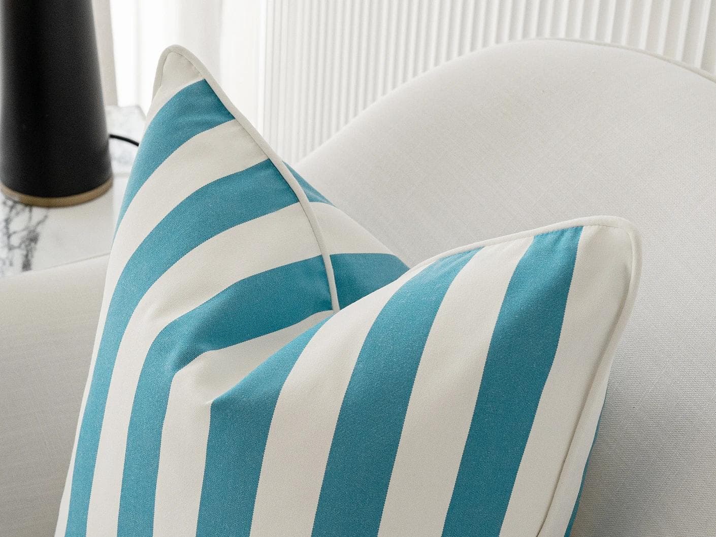 Aelia Azure cushion in blue and soft ivory, shown in a lifestyle right view as image 6