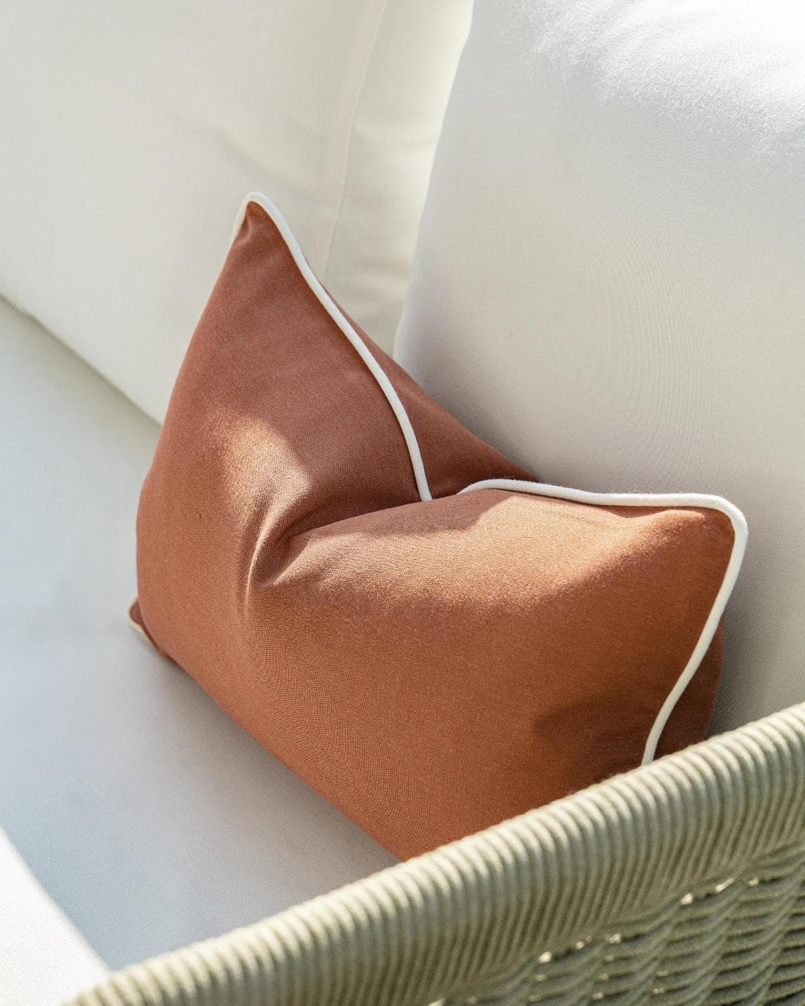 Aelia Clay II cushion in rust, shown in a lifestyle right view as image 5