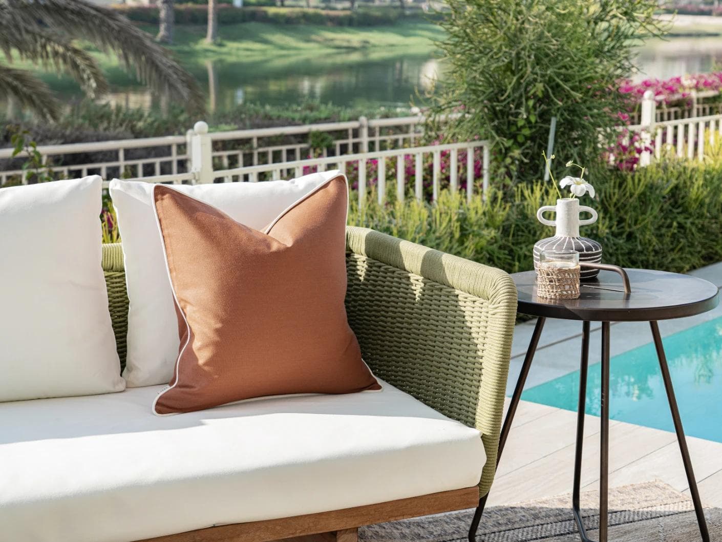 Aelia Clay cushion in rust, shown in a lifestyle left view as image 2