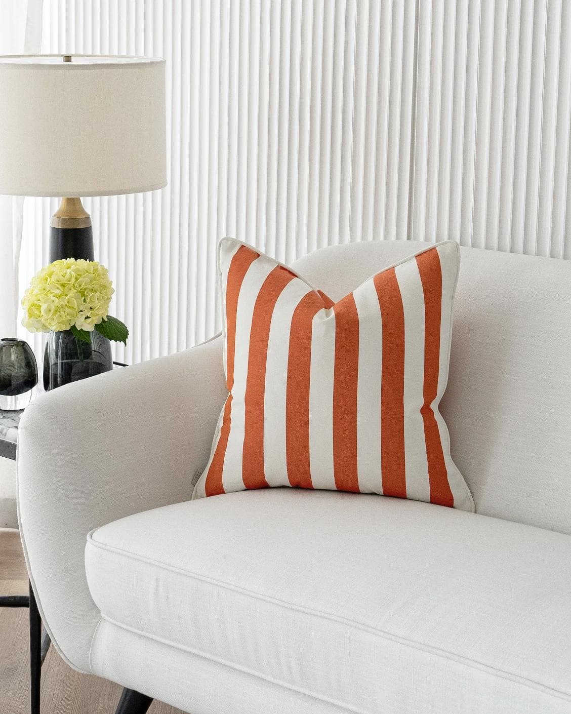 Aelia Coral cushion in orange, shown in a lifestyle front view as image 4