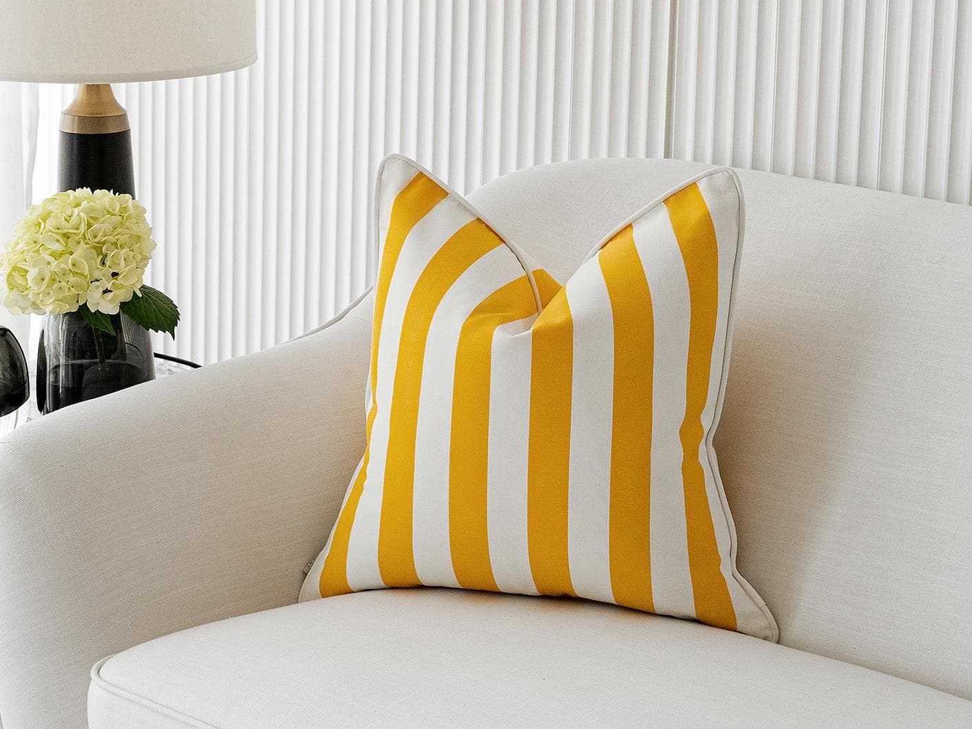 Aelia Gaze cushion in yellow, shown in a lifestyle front view as image 2