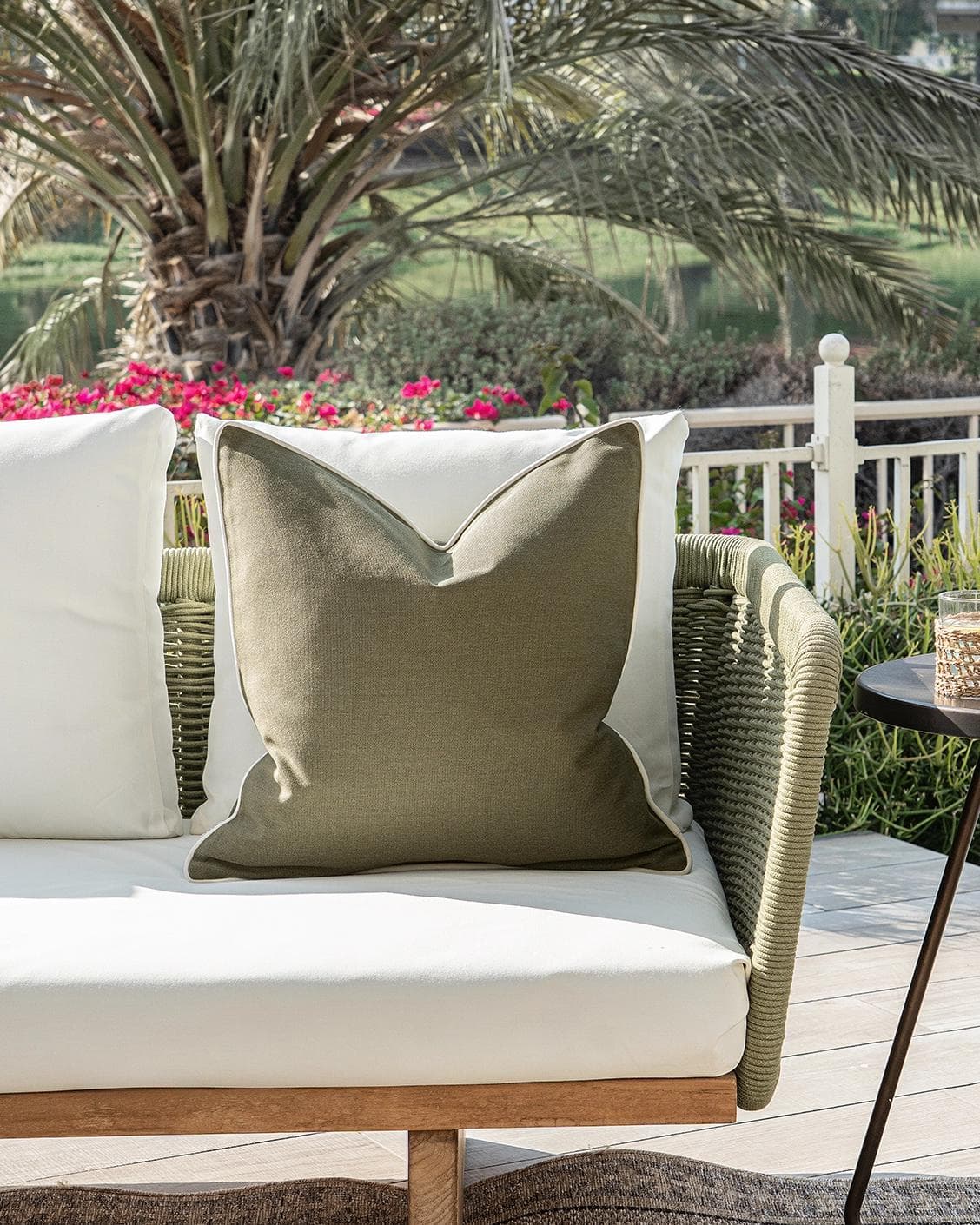Aelia Olive cushion in deep olive and green, shown in a lifestyle front view as image 4