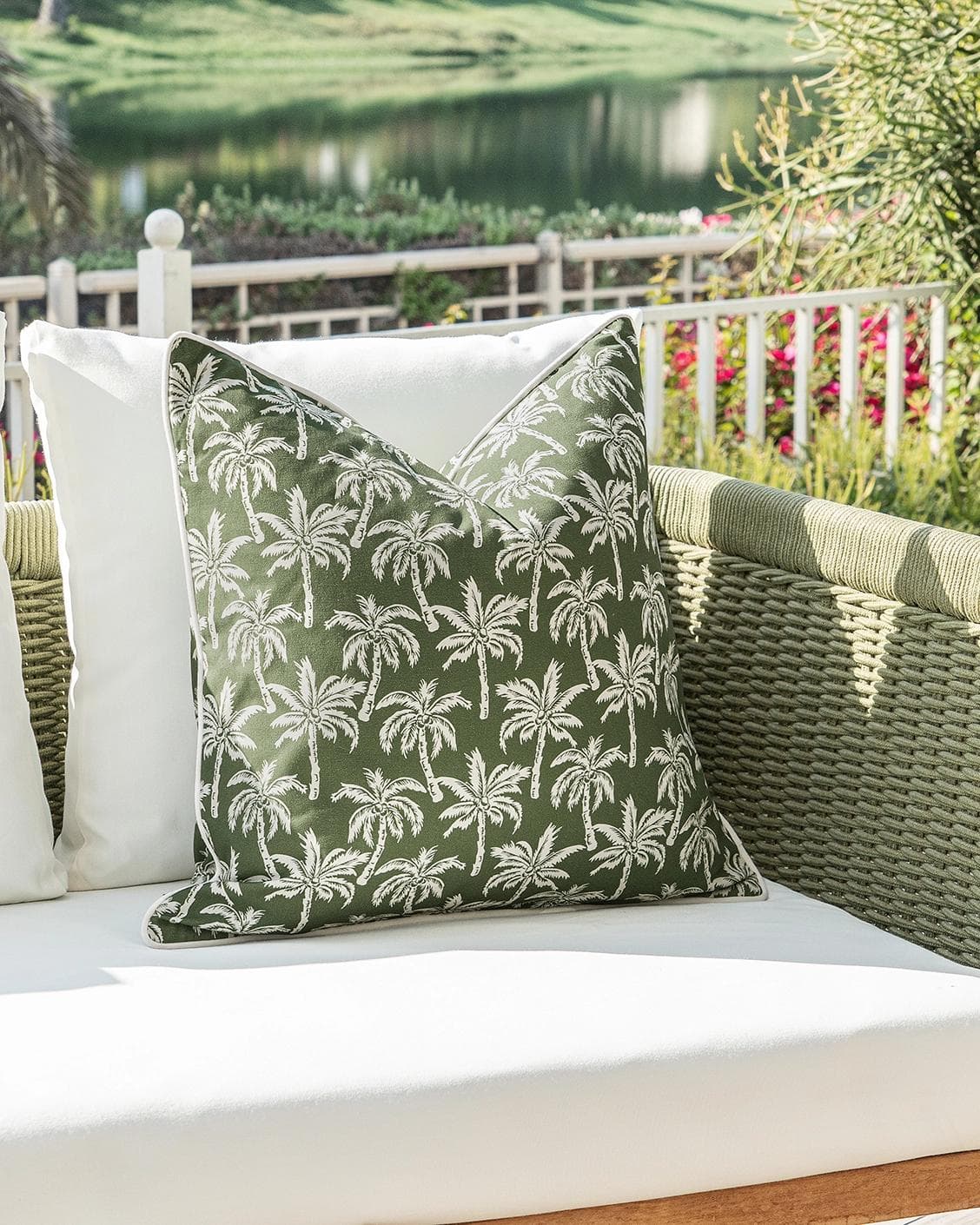 Aelia Palm cushion in green, shown in a lifestyle left view as image 2