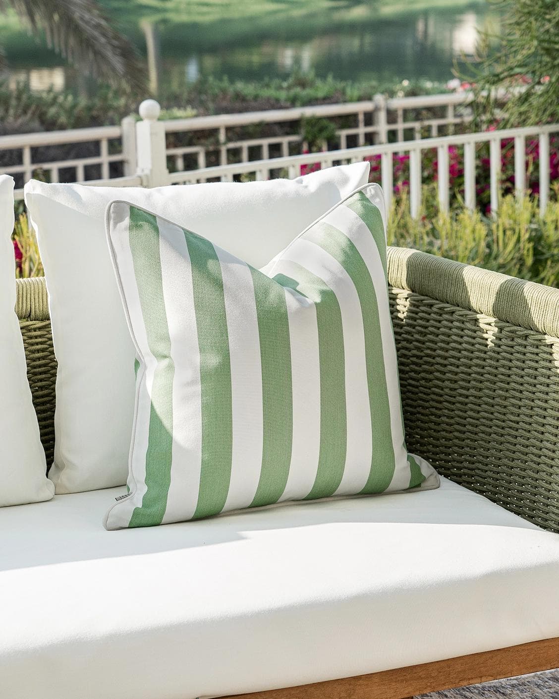 Aelia Pistachio cushion in forest green and green, shown in a lifestyle left view as image 2