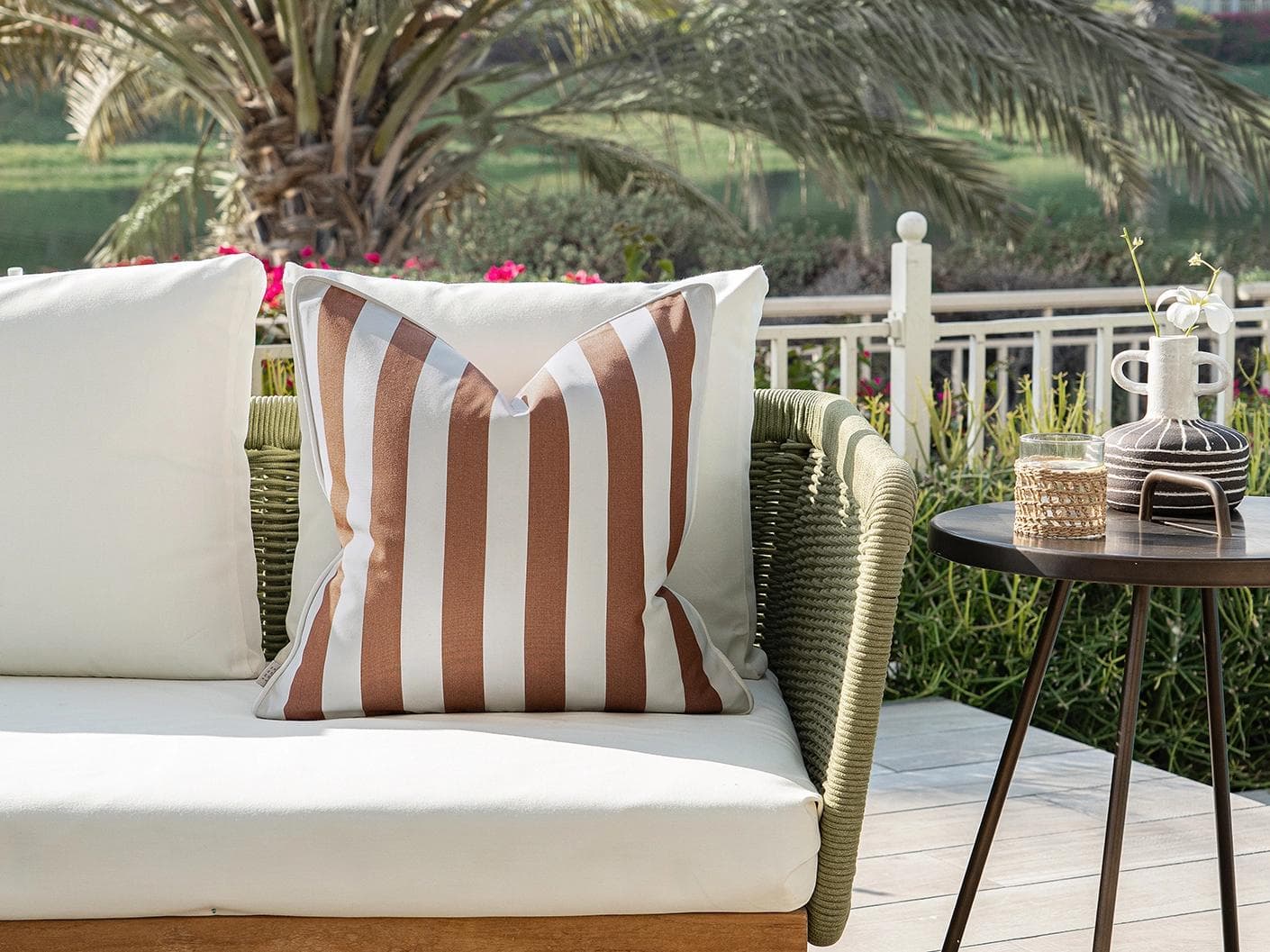 Aelia Rust cushion in ivory, shown in a lifestyle front view as image 4