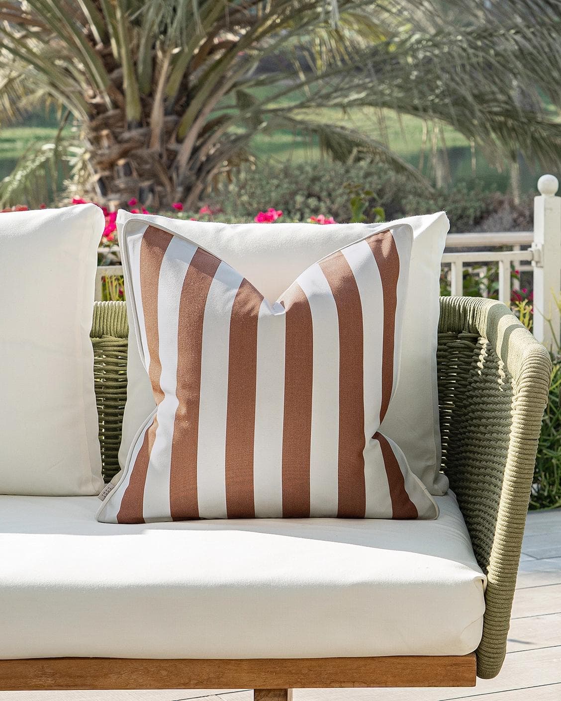 Aelia Rust cushion in ivory, shown in a lifestyle front view as image 4