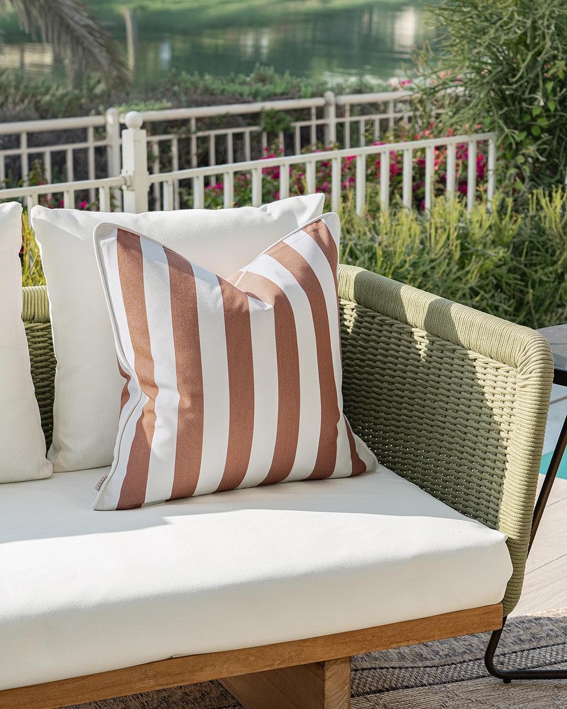 Aelia Rust cushion in ivory, shown in a lifestyle left view as image 2