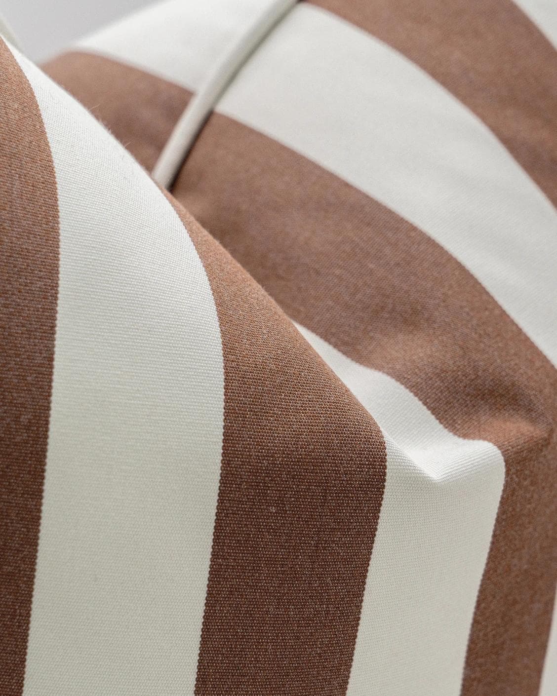 Aelia Rust cushion in ivory, shown in a product close-up as image 6