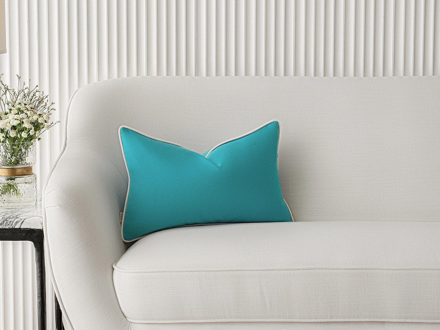 Aelia Sky II cushion in coral and blue, shown in a lifestyle front view as image 4
