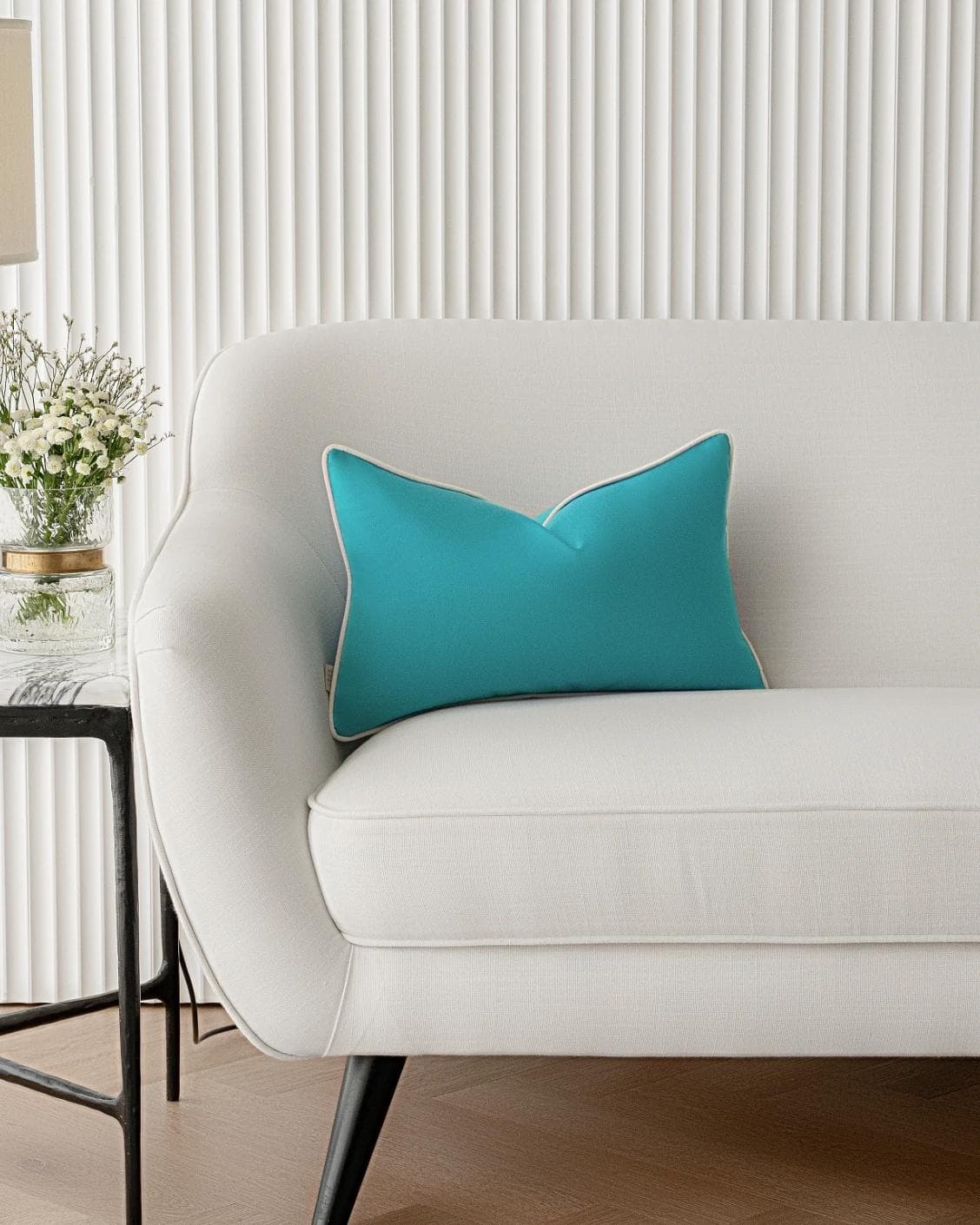 Aelia Sky II cushion in coral and blue, shown in a lifestyle front view as image 4