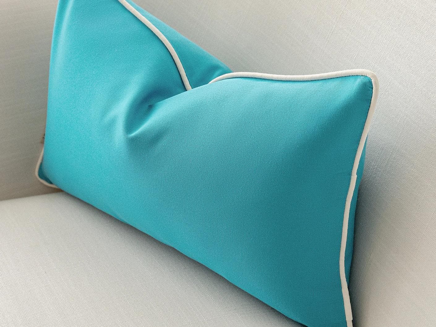 Aelia Sky II cushion in coral and blue, shown in a lifestyle right view as image 6