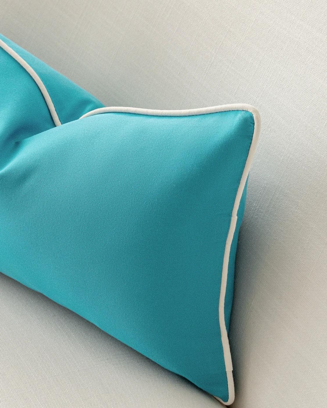 Aelia Sky II cushion in coral and blue, shown in a lifestyle right view as image 6
