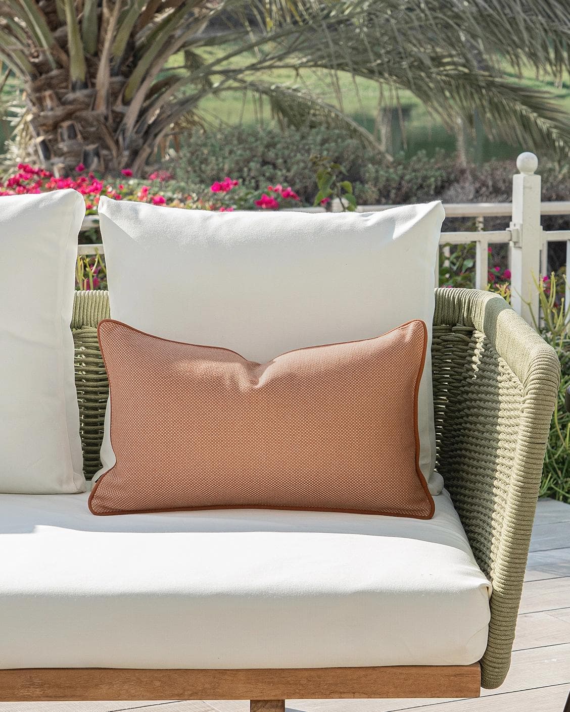 Aelia Tangelo II cushion in rust, shown in a lifestyle front view as image 4