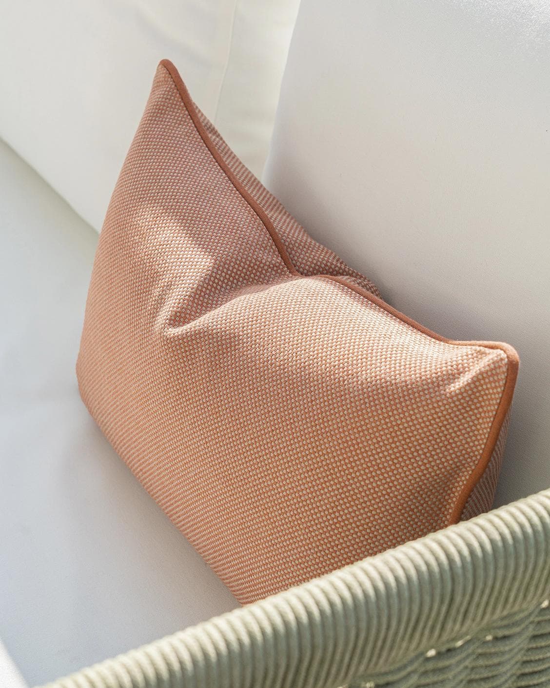 Aelia Tangelo II cushion in rust, shown in a lifestyle top view as image 5