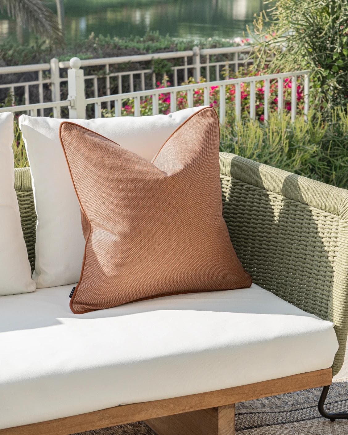 Aelia Tangelo cushion in rust, shown in a lifestyle left view as image 2
