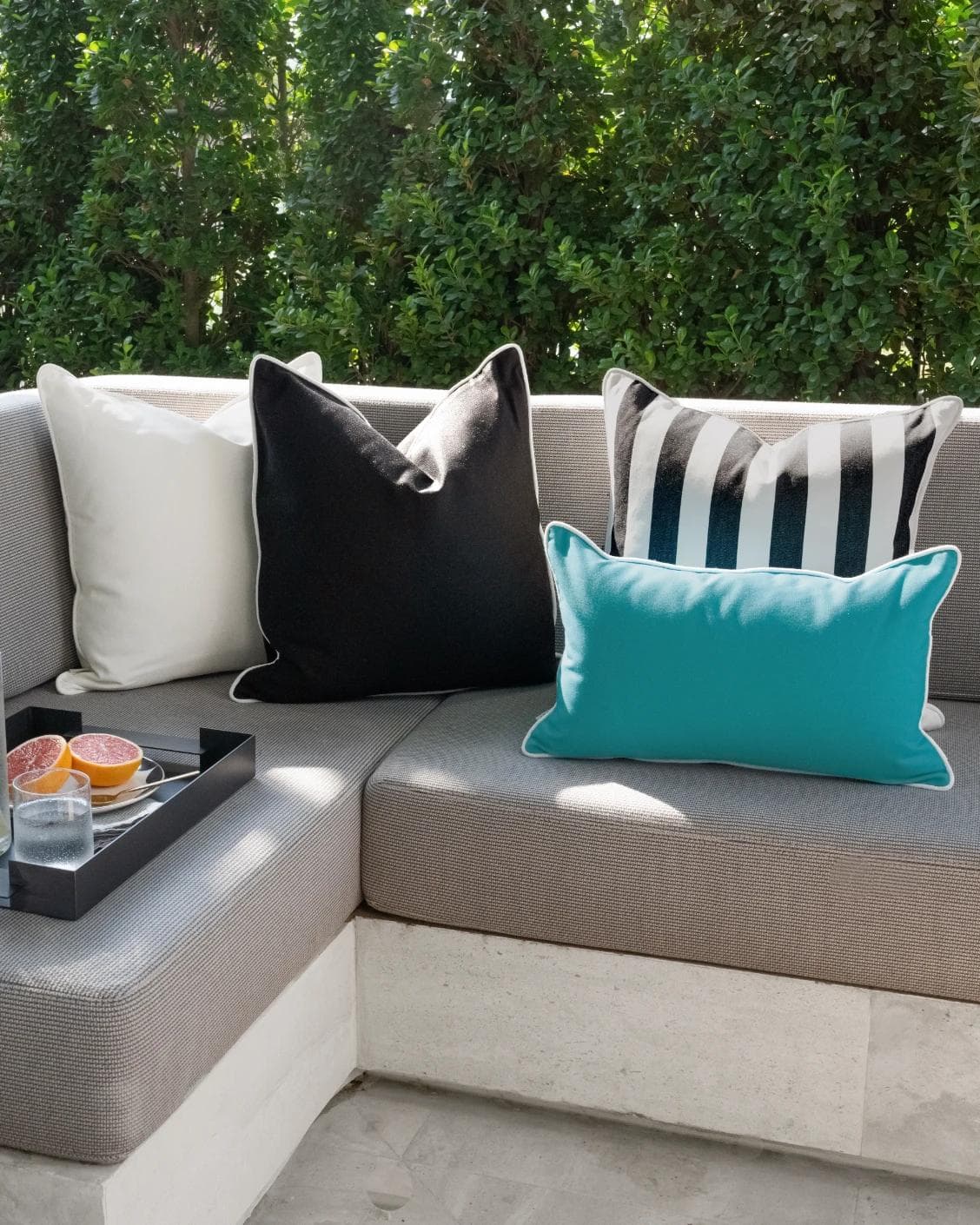 Aelius Bundle cushion in ivory, turquoise and black, shown in a lifestyle front view as image 4